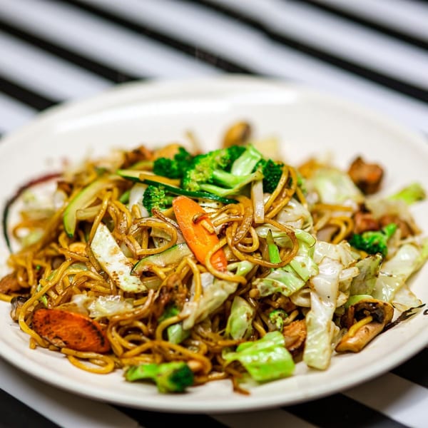 A close-up of Nori Teriyaki Mukilteo's yakisoba noodles with chicken, broccoli, cabbage, and carrots.