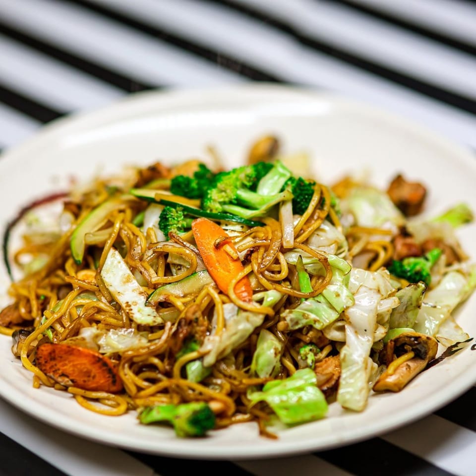 A close-up of Nori Teriyaki Mukilteo's yakisoba noodles with chicken, broccoli, cabbage, and carrots.