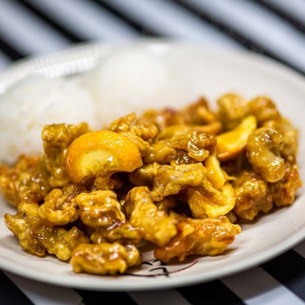 Nori Teriyaki Mukilteo's orange chicken, glistening with sauce, served with white rice on a white plate.