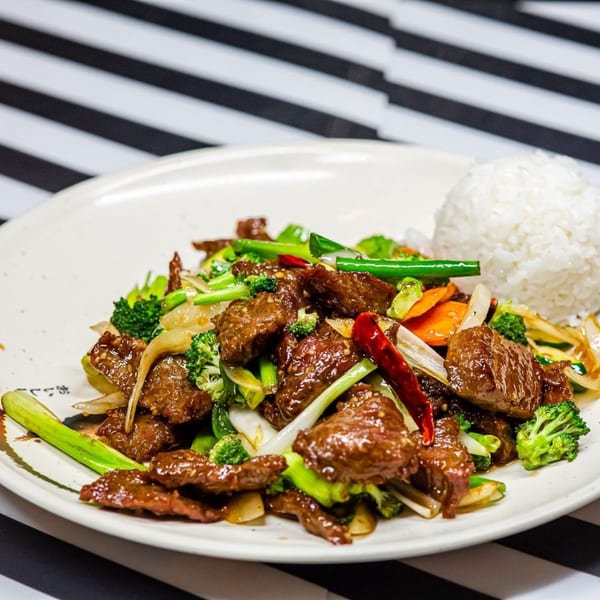 Nori Teriyaki Mukilteo's beef and broccoli stir-fry with white rice on a white plate.