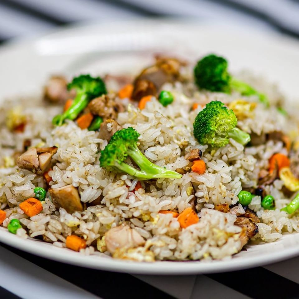 Close-up of Nori Teriyaki Mukilteo's chicken fried rice with broccoli, carrots, and peas.