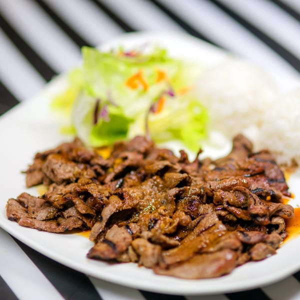 Nori Teriyaki Mukilteo's beef teriyaki with white rice and a side salad on a white plate.